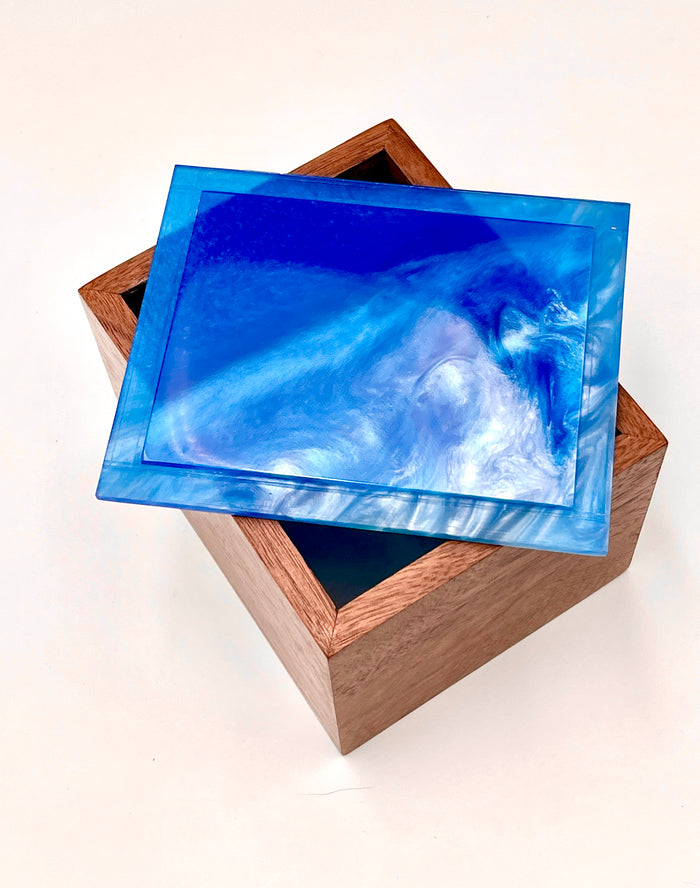 Handmade walnut keepsake box with an ocean blue epoxy resin lid